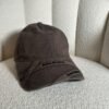 Acne Studios crossed-strap baseball cap in brown, front view