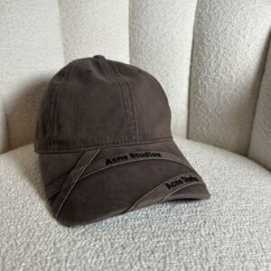 Acne Studios crossed-strap baseball cap in brown, front view