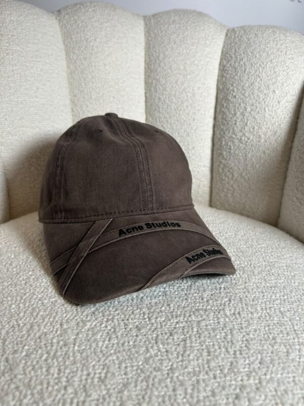 Acne Studios crossed-strap baseball cap in brown, front view