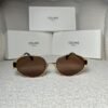 Gold-tone oval sunglasses with brown gradient lens