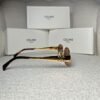 Gold-tone oval sunglasses with tortoiseshell temple tips, side view