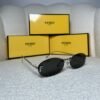 Silver rimless oval sunglasses with crystal-set detail, angled view