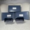 Gucci 58137 oversized square sunglasses in black, front view with presentation boxes
