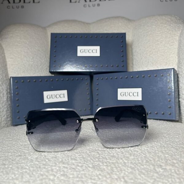Gucci 58137 oversized square sunglasses in black, front view with presentation boxes