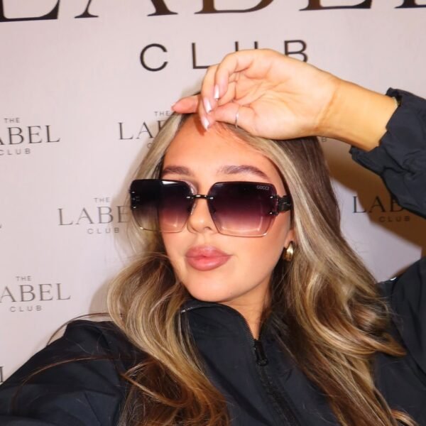 Model wearing Gucci 58137 oversized square sunglasses in black