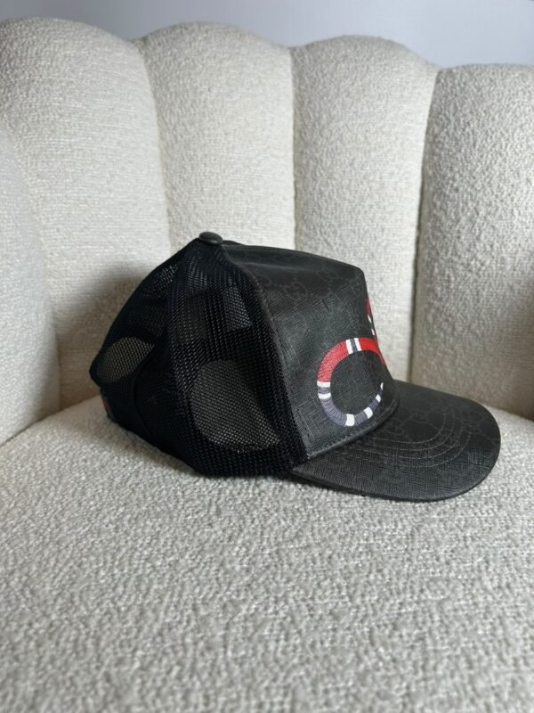 Gucci GG Supreme kingsnake trucker cap in black, side view with mesh back
