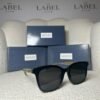 Black oversized square sunglasses, angled view showing the clear temple