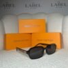Black rectangular sunglasses, angled view showing the gold monogram temple plaque