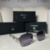 Silver rounded square sunglasses, angled view showing the lattice temple panel