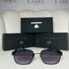 Matte black rounded square sunglasses with a gold nose bridge