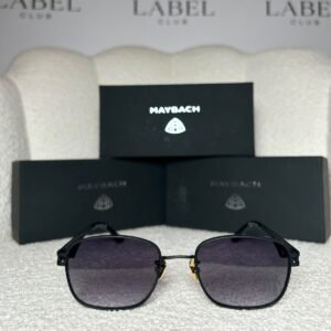 Matte black rounded square sunglasses with a gold nose bridge