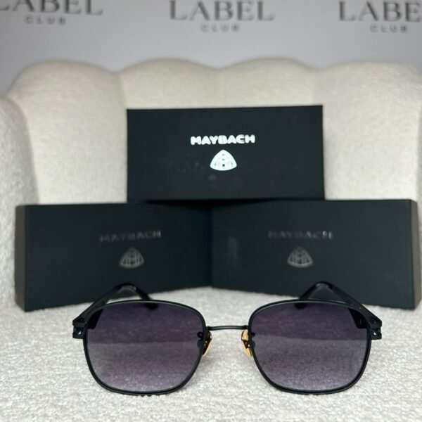 Matte black rounded square sunglasses with a gold nose bridge