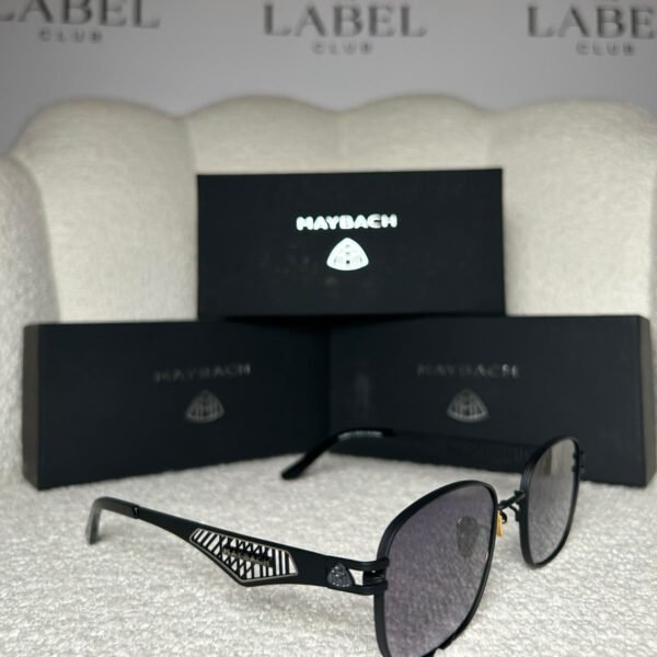 Matte black rounded square sunglasses, angled view showing the lattice temple panel