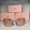 Oversized rimless sunglasses with pink gradient lenses and gold temples