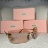 Oversized rimless sunglasses with pink gradient lenses, angled view