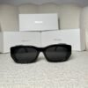 Black rectangular sunglasses with dark grey lenses