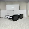 Black rectangular sunglasses with white inner temples, angled view