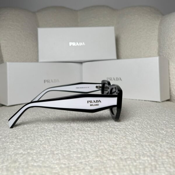 Black rectangular sunglasses with white inner temples, side view