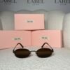 Black rimless oval sunglasses with brown lenses