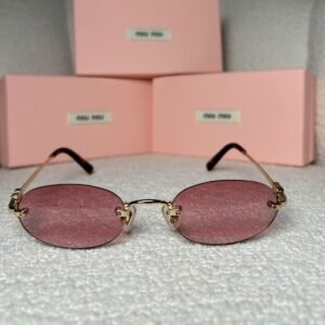 Gold rimless oval sunglasses with rose-pink lenses