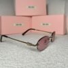 Gold rimless oval sunglasses with tortoiseshell tips, angled view