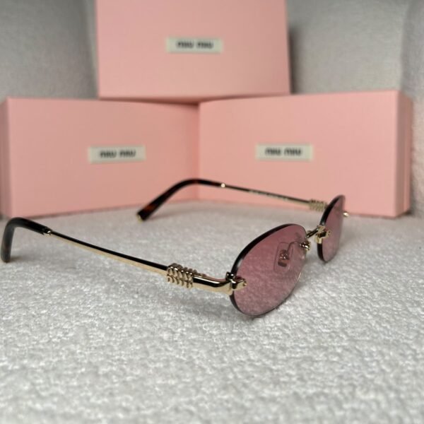 Gold rimless oval sunglasses with tortoiseshell tips, angled view